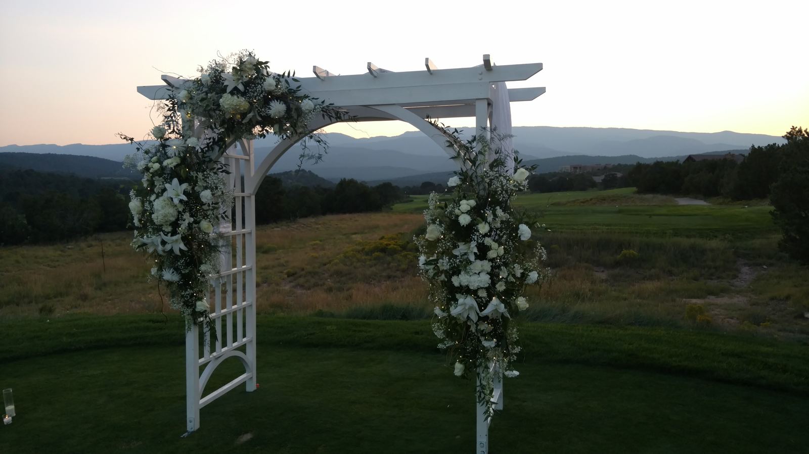 Wedding ceremony arch at sunset with mountain views